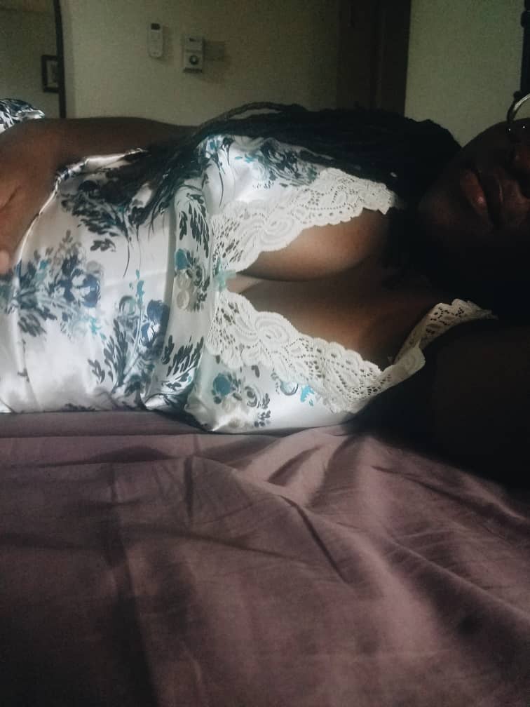 Woman lying on a bed in a nightie