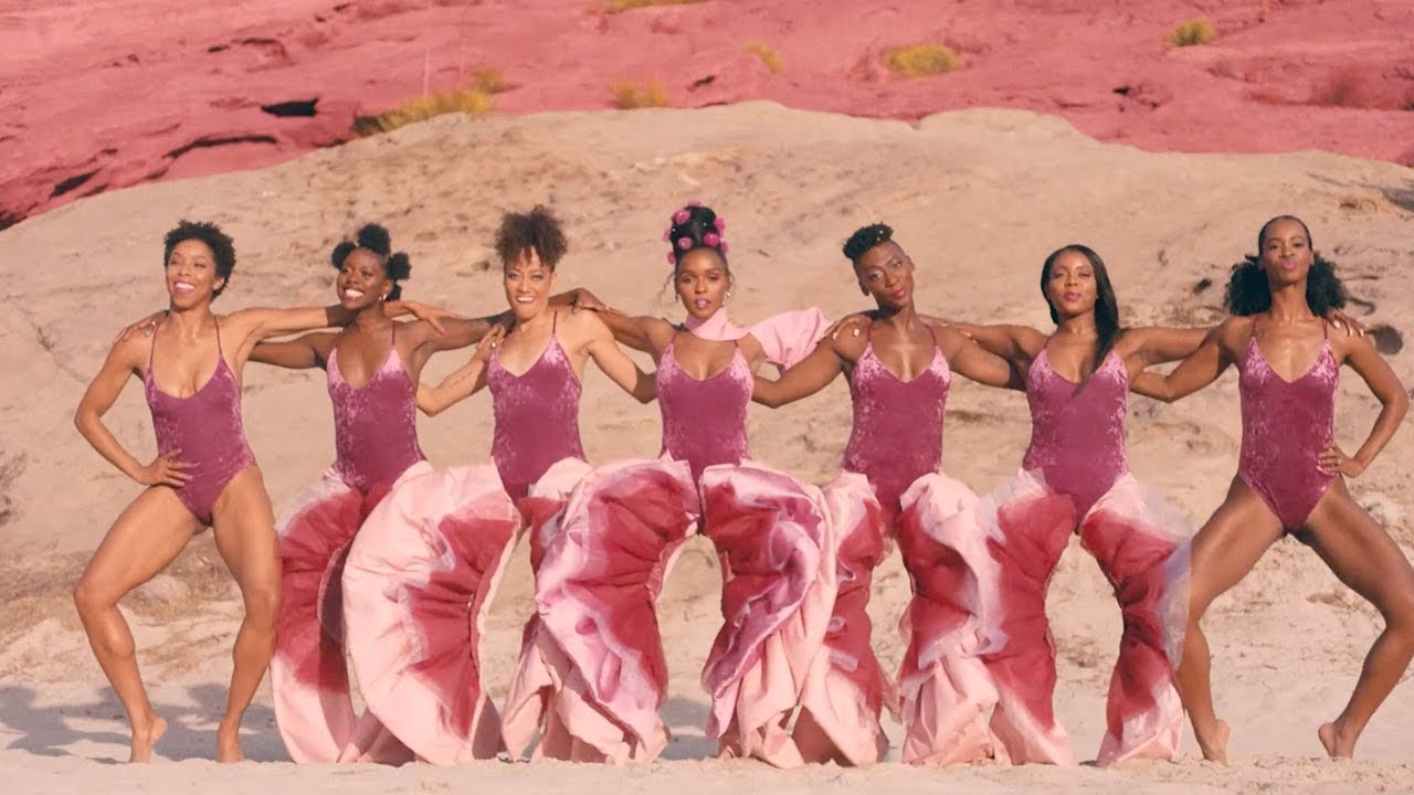 Image of Janelle Monae and 6 other black women wearing pink outfits