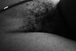 A black and white photo of African woman with bushy pubic hair